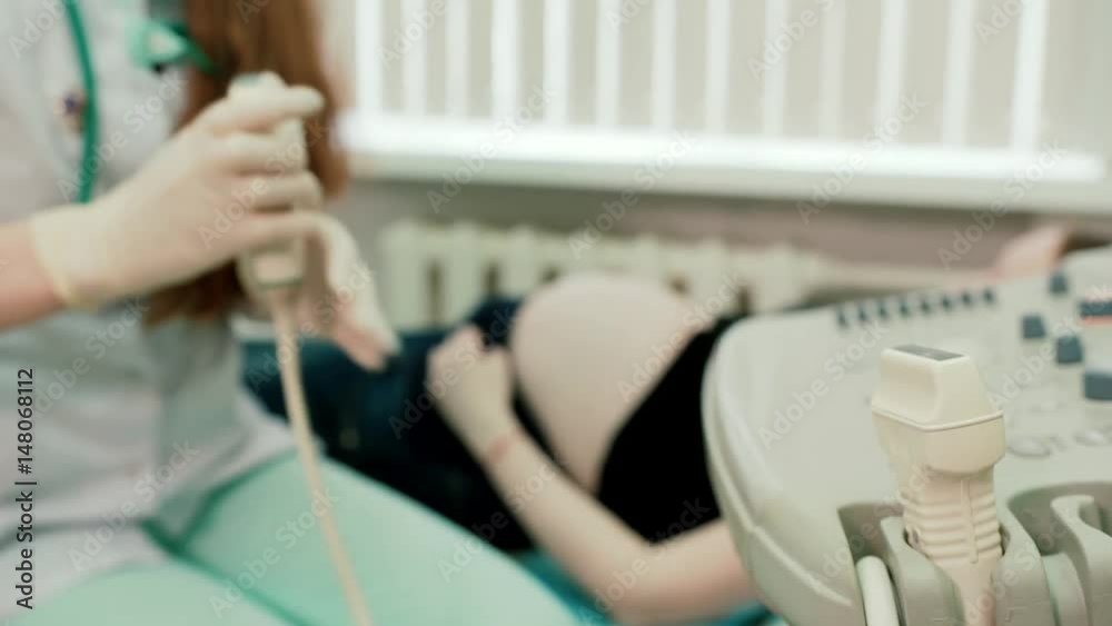 Girl doctor prepares for ultrasound examination Girl doctor prepares for ultrasound examination