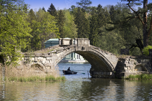 The ancient destroyed bridge in the former palace park. Gatchina. Petersburg. Russia...