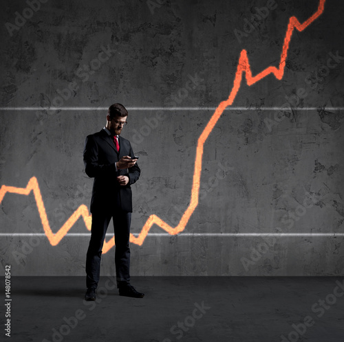 Businessman with smartphone standing over diagram background. Business, office, success, concept.