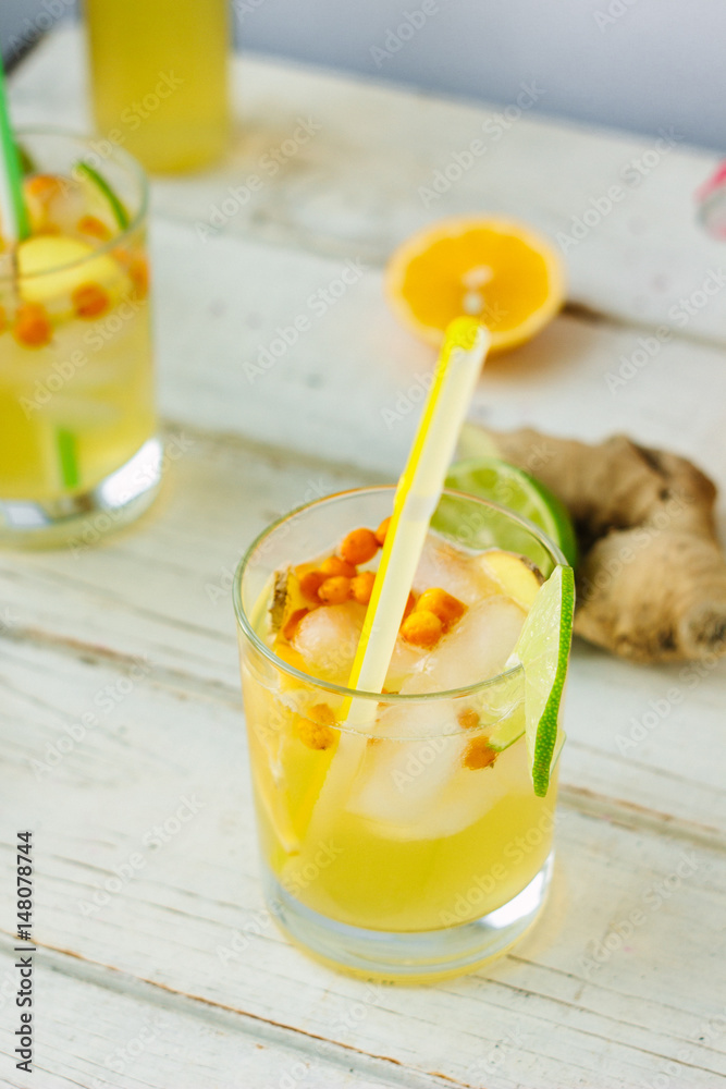 Fototapeta premium Fresh Ginger lemonade over white wooden background