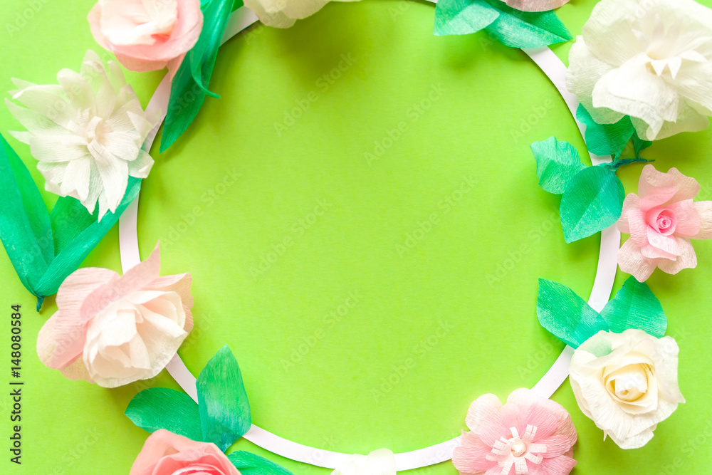 Round frame with color paper flower on green background. Round frame with color paper flower on green background.