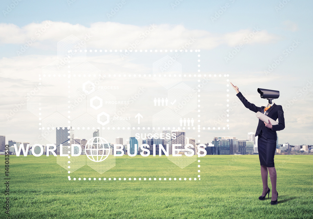 Camera headed woman standing on green grass against modern citys