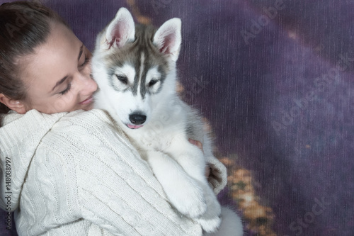 happy girl and husky puppy