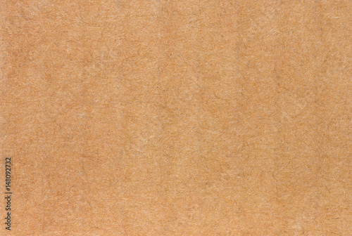 Close up of side view of a textured recycled packing cardboard with natural fiber parts