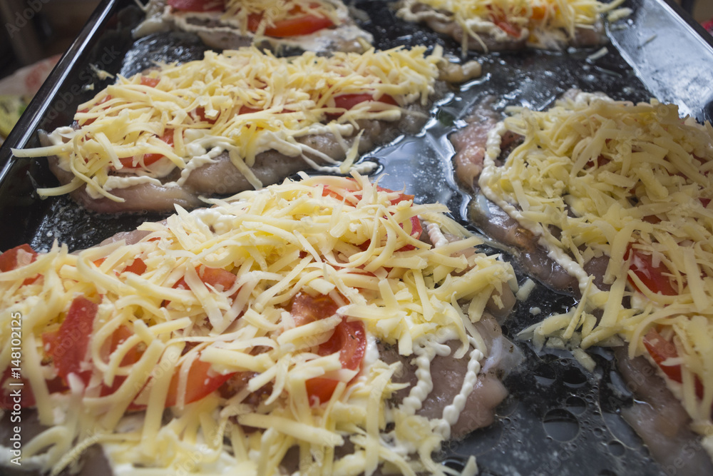 Tomato segments laid on chicken fillet with cheese Tomato segments laid on chicken fillet with cheese