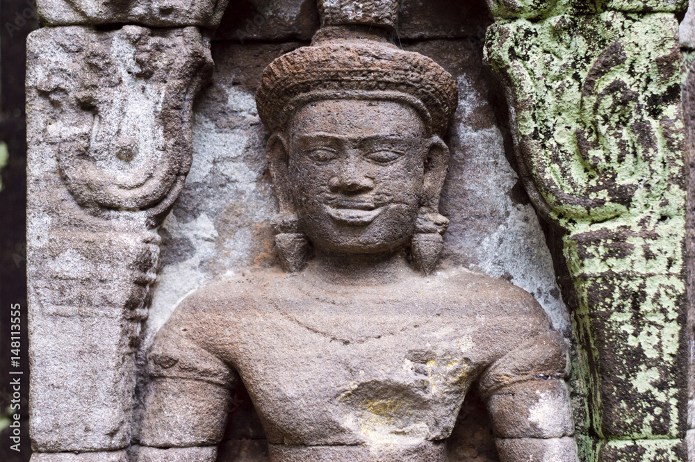 Carved in stone sculptures on the facade of Vat Phou (or Wat Phu) - Khmer Hindu temple complex in Champasak Province, southern Laos