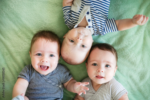 Bilde på lerret Portrait of newborn triplets are lying in the bed