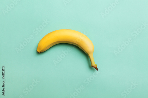 ripe banana on a background of mint color