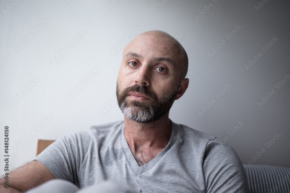 Mid forties depressed man in bed at home Mid forties depressed man in bed at home