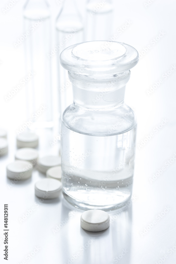 doctor's office table with pills and vials white background doctor's office table with pills and vials white background