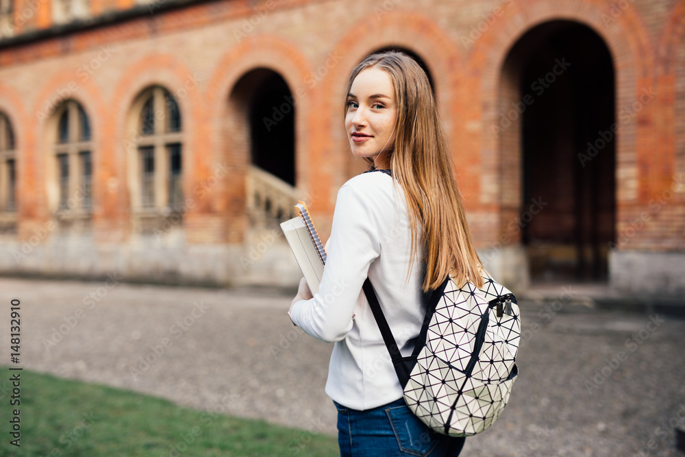happy student girl with school bag and notebooks outdoors
