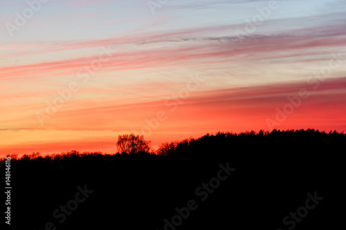 Fototapeta Naklejka Na Ścianę i Meble -  sunset over a hill top - silhouette