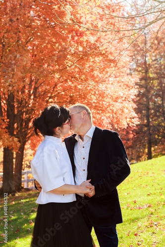 Autumn couple walking park and kissing. Autumn friends walk outdoor. photo