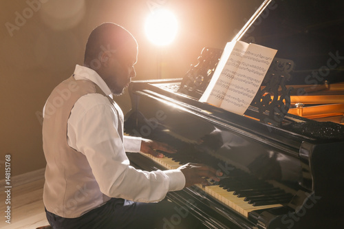 Afro American man playing piano photo