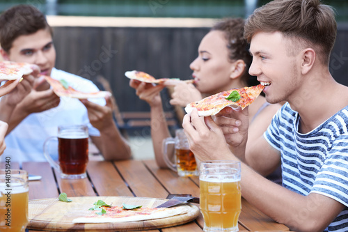Happy friends in pizzeria