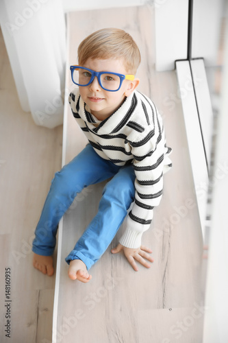 Cute little boy sitting on ...