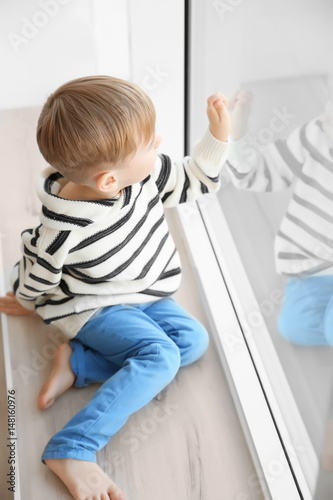 Cute little boy sitting on ...