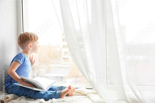 Cute little boy with book s...