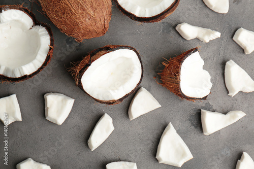 Fresh coconut slices on gray background
