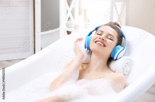 Vászonkép Beautiful young woman taking bath at home