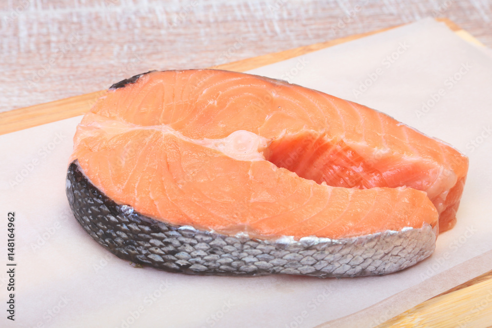 fresh raw salmon with spices on wooden cutting board. ready for cookin fresh raw salmon with spices on wooden cutting board. ready for cookin