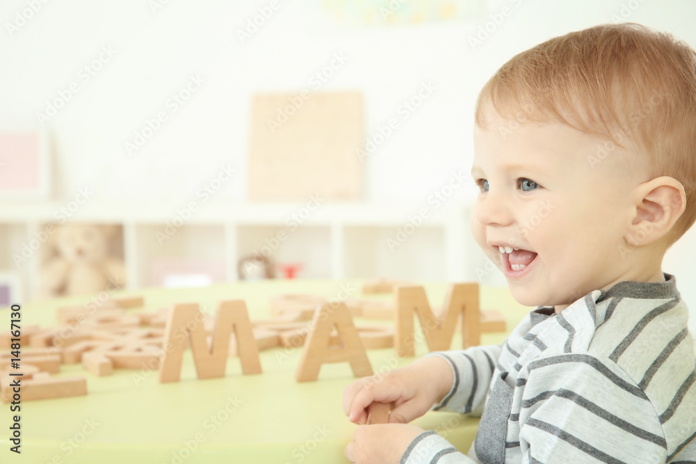 Cute little child playing with letters at home Cute little child playing with letters at home