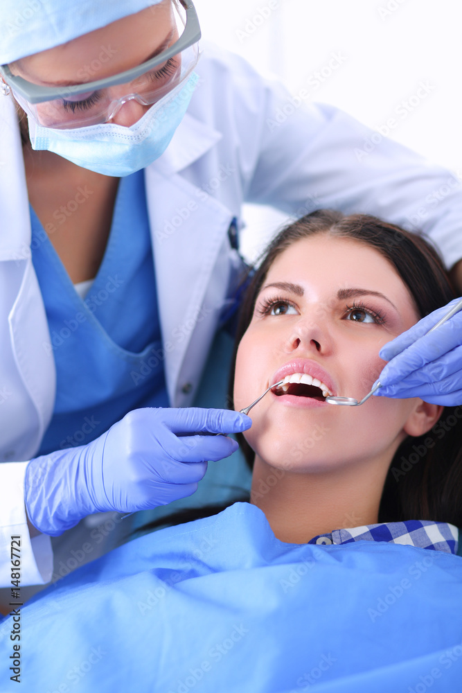 Woman dentist working at her patients teeth Woman dentist working at her patients teeth