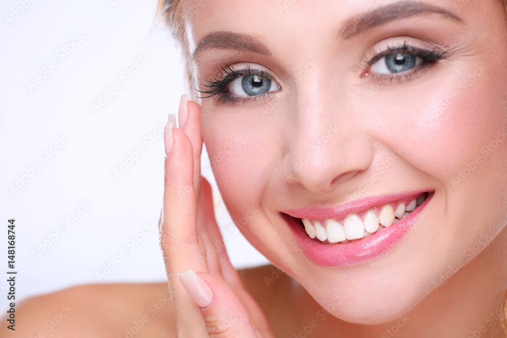 Young woman touching her face isolated on white background Young woman touching her face isolated on white background