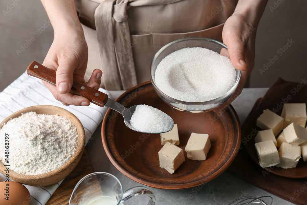 Woman making dough for a pie in bowl Woman making dough for a pie in bowl