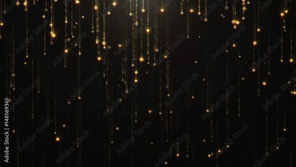 Falling gold particles flicker and shimmer against a black background. Abstract background for fashion glamor and wealth prosperity