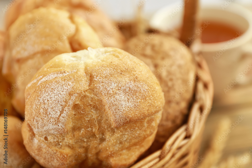 Wicker basket with different fresh bread buns, closeup