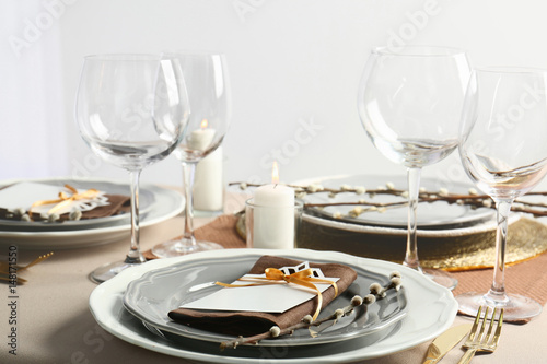 Beautiful table setting with golden cutlery