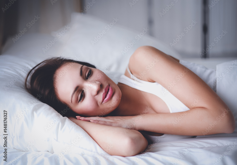 Fototapeta premium Pretty woman lying in bed