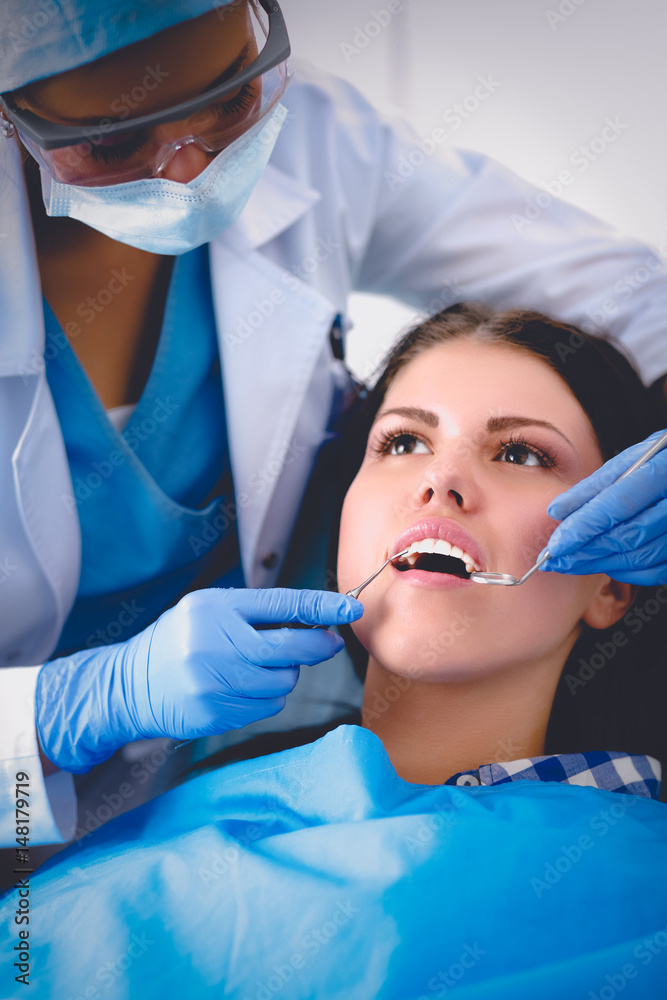 Woman dentist working at her patients teeth Woman dentist working at her patients teeth