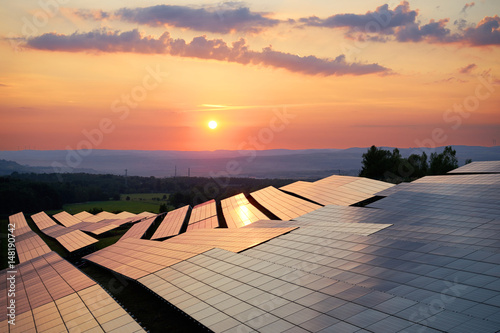 Obraz na płótnie Photovoltaic panels of solar power station in the landscape at sunset. View from above. w salonie