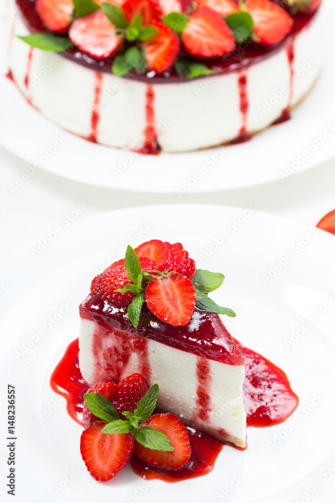 Cheesecake with strawberries and mint leaves on a white plate
