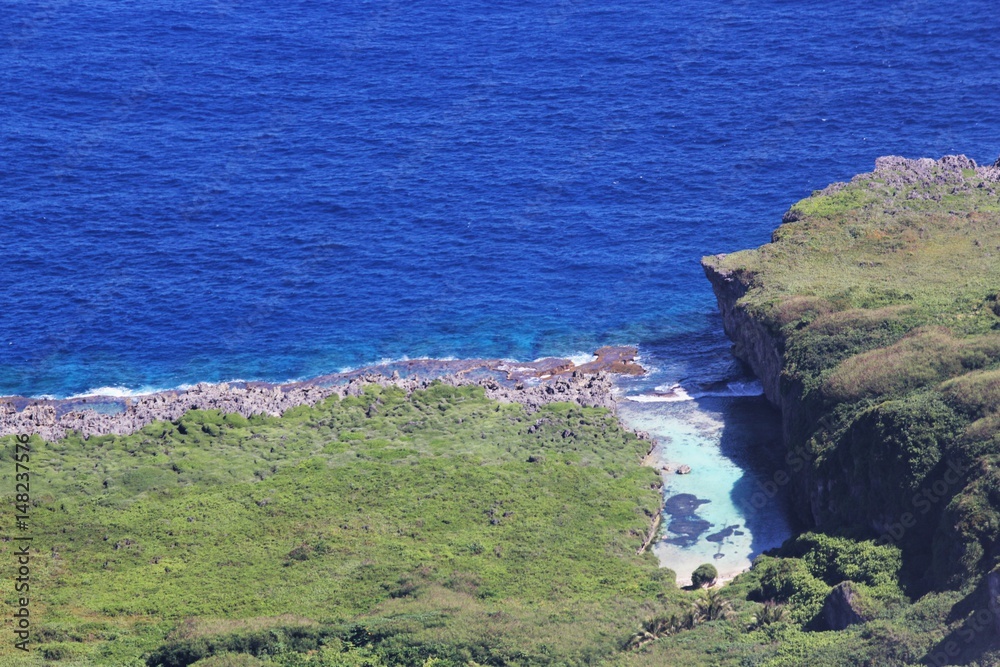 Fototapeta premium Aerial view of Tinian coast Aerial view of a hidden strip of water inlet in the North Field, Tinian, Northern Mariana Islands 