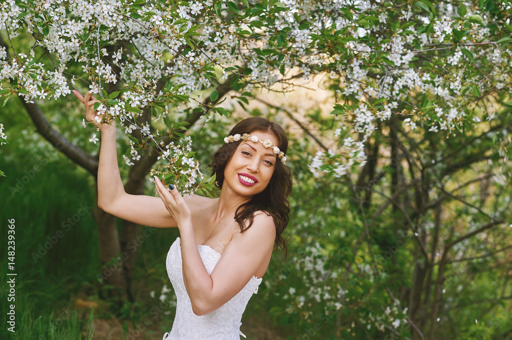 Young beautiful bride in the flowered garden . Wedding day Young beautiful bride in the flowered garden . Wedding day