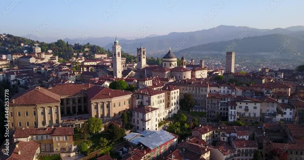 Drone aerial view of Bergamo - Old city (Citta' Alta). One of the beautiful city in Italy. Landscape on the city center, the main square and its historical buildings during a wonderful blu day Drone aerial view of Bergamo - Old city (Citta' Alta). One of the beautiful city in Italy. Landscape on the city center, the main square and its historical buildings during a wonderful blu day