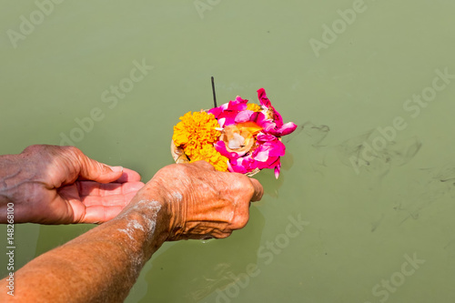 Doing puja at the river Ganges in India Stock Photo | Adobe Stock