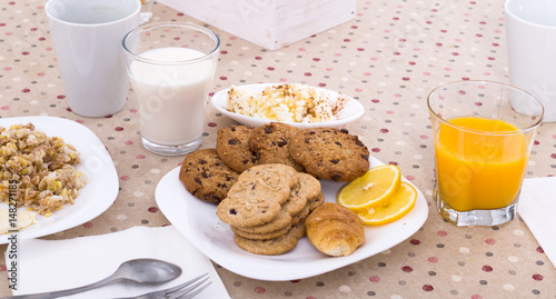 still life of juice, milk, biscuits, porridge from cereals photo