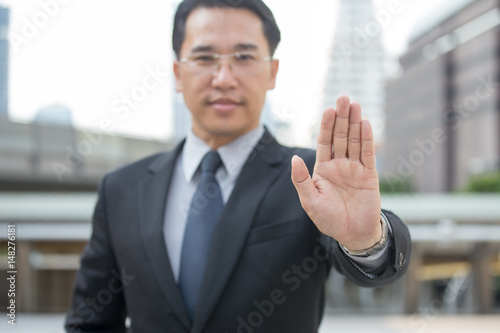 Businessman's showing hand for ban some rule