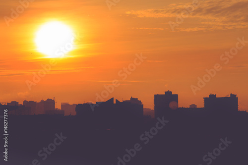 Sunrise and silhouette of modern city © Aleksei Lazukov