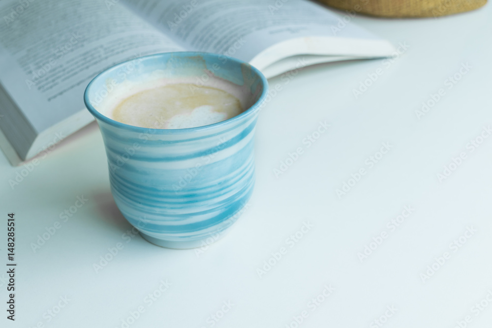 Blue coffee cup on the desk with books. Concept coffee lover background. Blue coffee cup on the desk with books. Concept coffee lover background.
