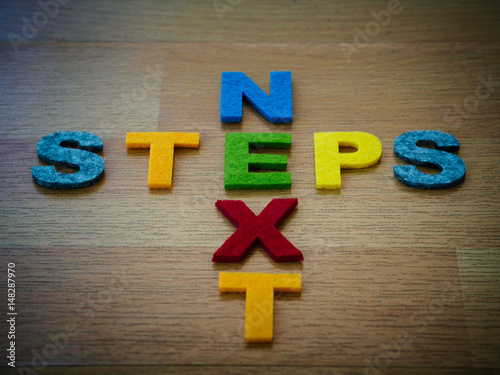 Wallpaper Mural next steps concept in colorful letters on wooden blackboard Torontodigital.ca