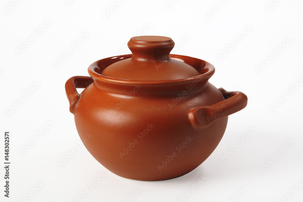 Pottery (brown pot with lid) on a white background. Isolated. Close-up. Pottery (brown pot with lid) on a white background. Isolated. Close-up.