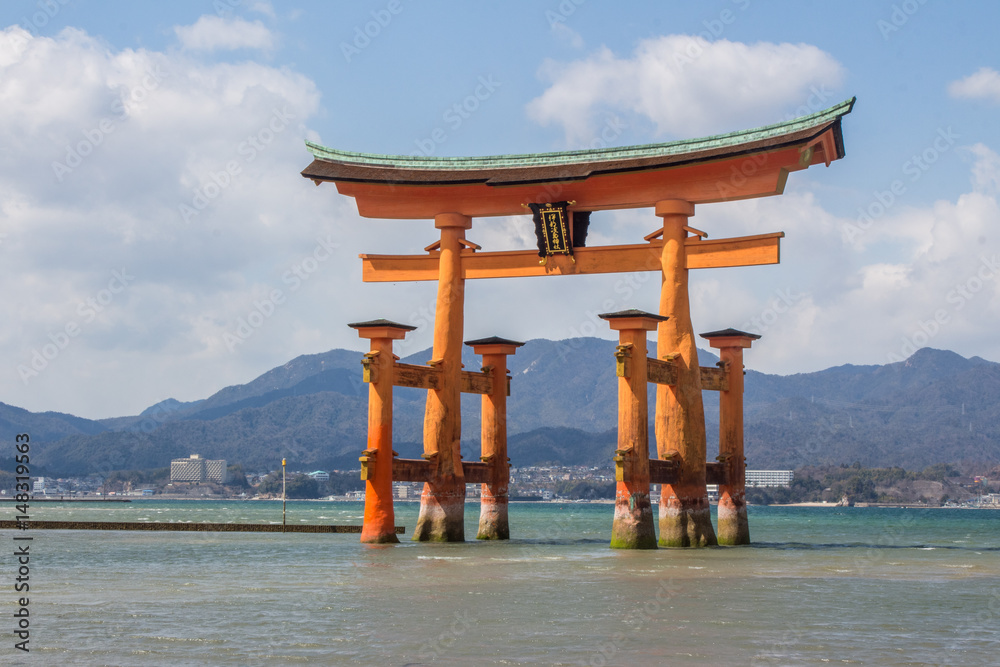 Orange floating Toji at Itsukushima and Miyajima Shinto Shrine outside Hiroshima, Japan on a bright sunny spring day at medium tide Orange floating Toji at Itsukushima and Miyajima Shinto Shrine outside Hiroshima, Japan on a bright sunny spring day at medium tide