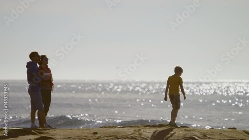 Happy family is spending time together on a coast
