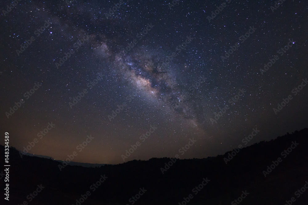 Milky way galaxy with stars over moutain at Phu Hin Rong Kla National Park,Phitsanulok Thailand, Long exposure photograph.with grain