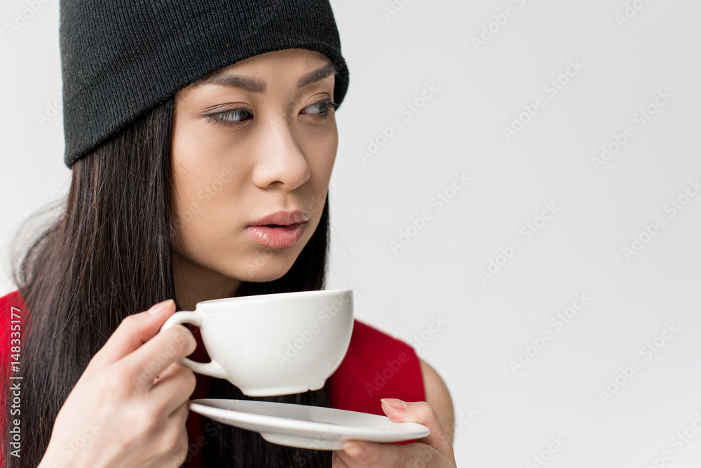 portrait of attractive asian woman holding tea cup isolated on grey portrait of attractive asian woman holding tea cup isolated on grey